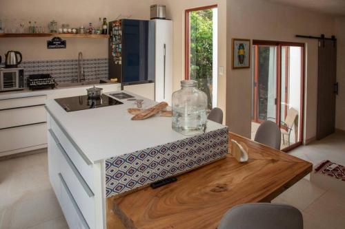 a kitchen with a counter with a bottle on it at Aldea Agape in Puerto Morelos