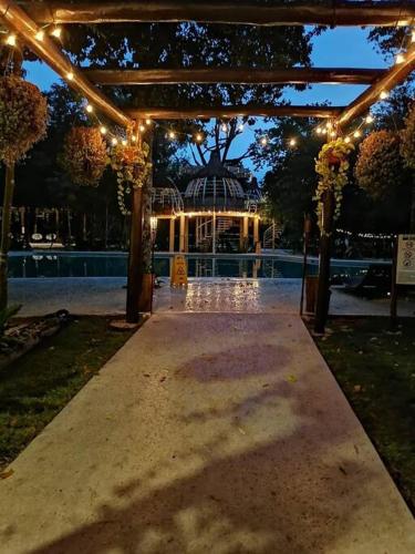 an outdoor pavilion with lights and a pool at night at Aldea Agape in Puerto Morelos