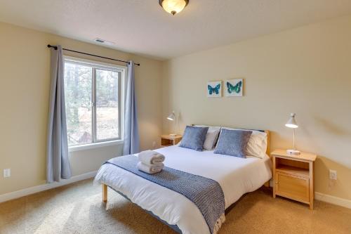 a bedroom with a large bed and a window at Bend Getaway with Private Hot Tub, Patio and Grill! in Bend