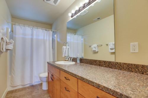 a bathroom with a sink and a toilet and a mirror at Bend Getaway with Private Hot Tub, Patio and Grill! in Bend