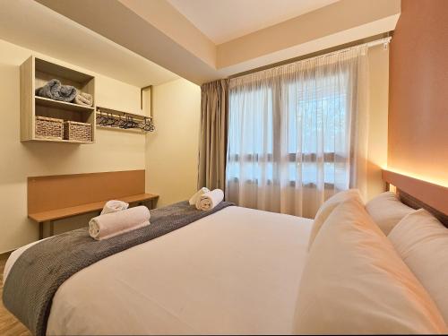 En eller flere senge i et værelse på Apartamentos Las Ciencias O