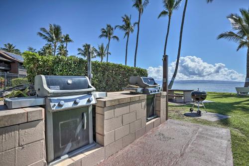 a grill and two burners on a brick wall next to the ocean at Kaunakakai Home at Molokai Shores with Pool! in Kaunakakai