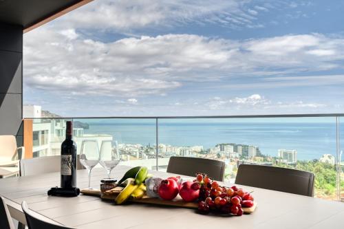 a table with a bunch of fruits and vegetables on it at Becas Place, a Home in Madeira in Funchal