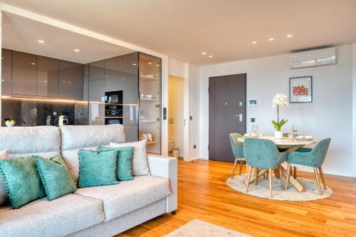 a living room with a couch and a table at Becas Place, a Home in Madeira in Funchal
