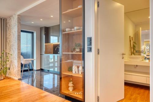 a room with a glass door leading into a kitchen at Becas Place, a Home in Madeira in Funchal