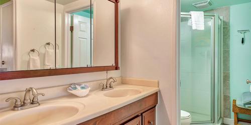 a bathroom with a sink and a glass shower at Molokai Shores by HI in Kaunakakai