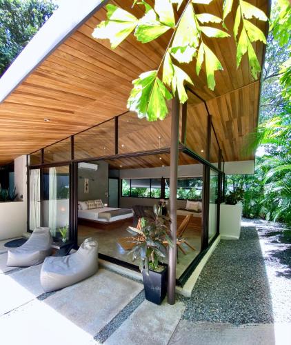 a modern house with a wooden roof at Villas Kalei in Playa Grande