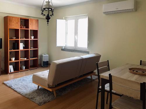 a living room with a couch and a table at Casa da Levada in Tomar