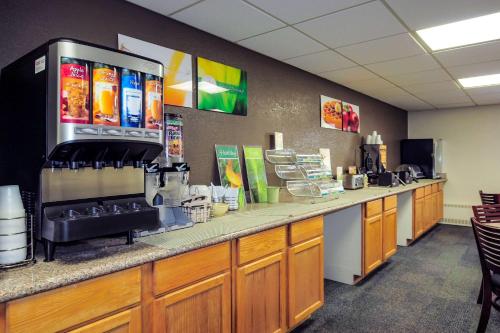 a coffee shop with a counter in a room at Quality Inn Stadium Area Green Bay Stadium in Green Bay