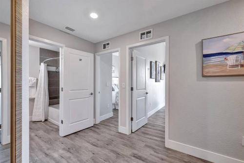 a hallway with white doors and wood floors in a house at Mangrove Magic in Little Harbor Resort & Marina in Ruskin
