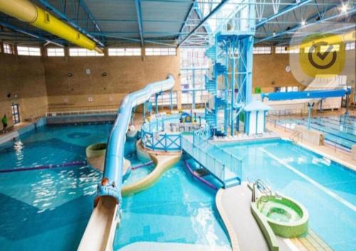 a swimming pool with a water slide in it at Your Riverside Home 3 with Private balcony in Woolwich