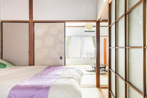 Ένα ή περισσότερα κρεβάτια σε δωμάτιο στο 新宿から快速15分の三鷹駅徒歩3分 最大5名 ゆったり和室【MITAKA NAGOMI ROOM】　