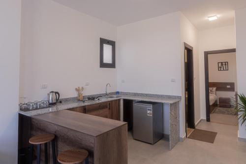 a kitchen with a counter with a sink and a refrigerator at Sola inn in Hurghada