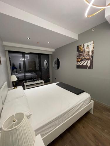 a bedroom with a white bed and a large window at 2 bedrooms apartment in 5 stars Hotel comfort in Istanbul