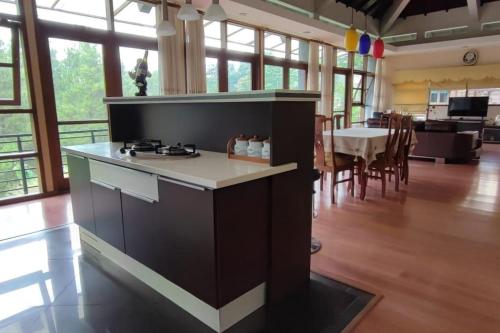 a kitchen with a stove and a dining room at PineHill on a 1740m land in Lembang