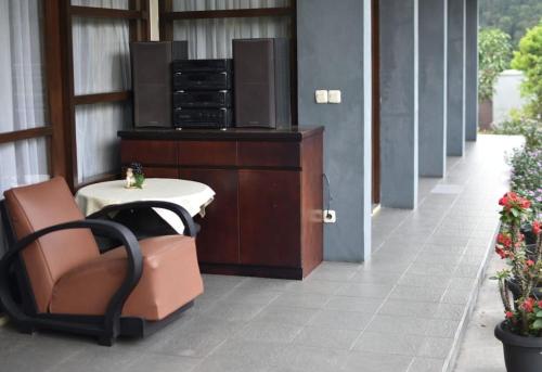 a room with a chair and a table in a building at PineHill on a 1740m land in Lembang