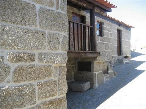 a brick building with a balcony on the side of it at Casa da Carreira in Amarante
