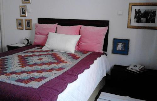 a bedroom with a bed with a quilt on it at Casa da Carreira in Amarante