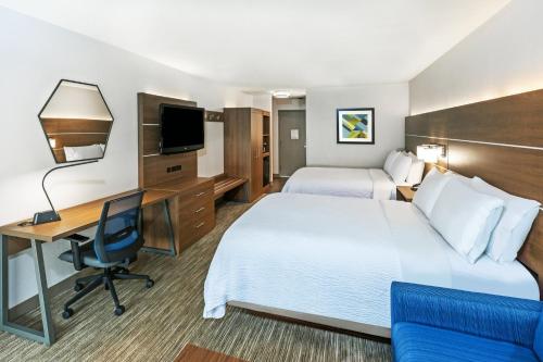 a hotel room with two beds and a desk at Holiday Inn Express & Suites Sulphur - Lake Charles, an IHG Hotel in Sulphur