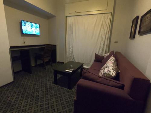 a living room with a couch and a flat screen tv at Borg El Thaghr Hotel in Alexandria