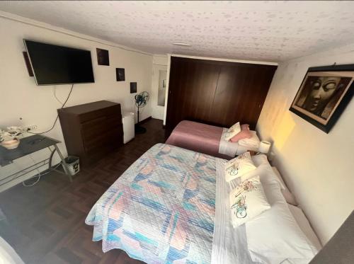 1 dormitorio pequeño con 1 cama y 1 sofá en Habitaciones en casa de alojamiento sector sur de Iquique, Chile en Iquique