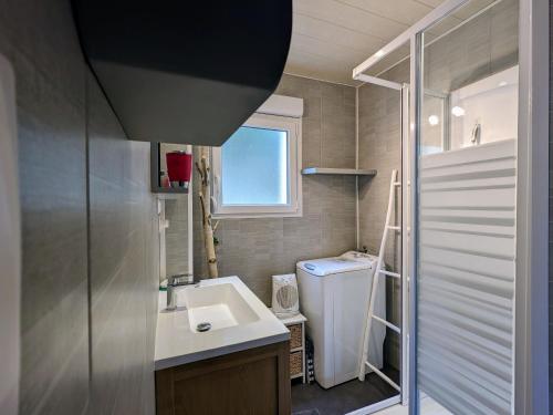 a bathroom with a sink and a washing machine at Charmant chalet de montagne avec terrasse et vue imprenable - FR-1-589-72 in Cornimont
