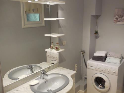 a bathroom with a sink and a washing machine at Gîte Saint-Dié-des-Vosges, 2 pièces, 2 personnes - FR-1-589-177 in Saint Die