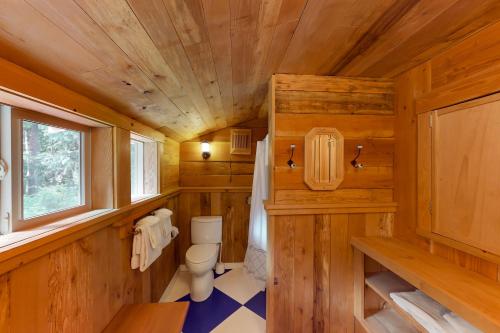 a small bathroom with a toilet and a window at The Canopy House in Clinton