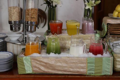 a tray filled with different colored candles in glass jars at Quinta Real Oaxaca in Oaxaca City