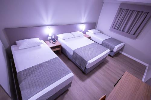 Postel nebo postele na pokoji v ubytování Hotel Caiuá Blumenau