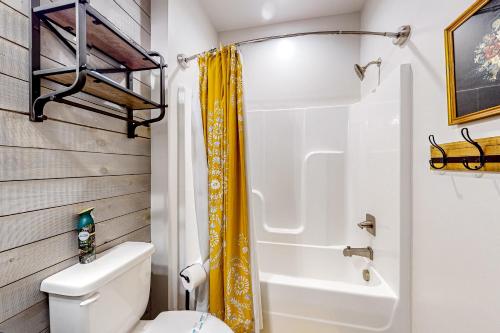 a bathroom with a white toilet and a shower at Firefly Meadows in Ellijay