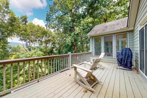 a porch with a rocking chair on a house at Top of the Trees Oasis in Jasper