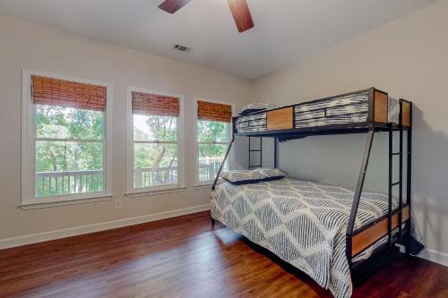 a bedroom with a bunk bed and two windows at Top of the Trees Oasis in Jasper