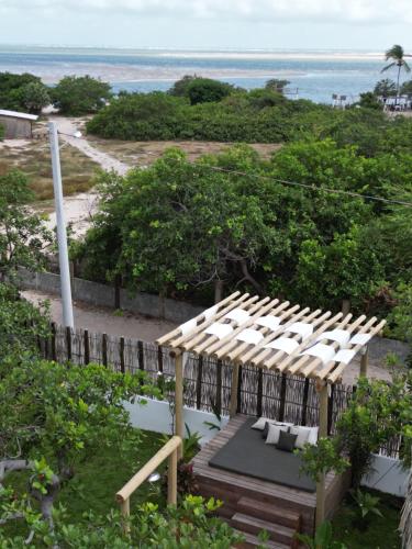 a wooden pergola with a view of the ocean at Pantai Atins in Atins