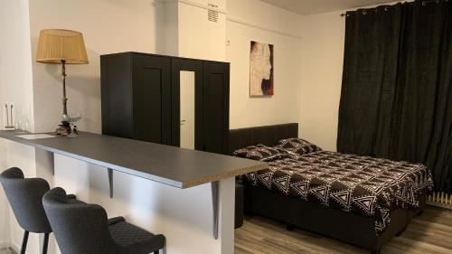 a room with a table and a bed and a table and chairs at A&A Studio in Rheine