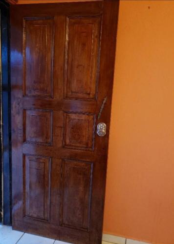 a wooden door in the corner of a room at Private 1 Bedroom shared house in La Ceiba