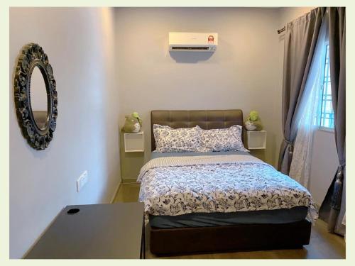 a bedroom with a bed and a air conditioner at PulauKetam HuaHeeHomes 吉胆岛欢喜亲子民宿 in Bagan Teochew