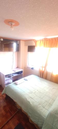 una camera con un grande letto e una finestra di Estefanyyyy a Latacunga