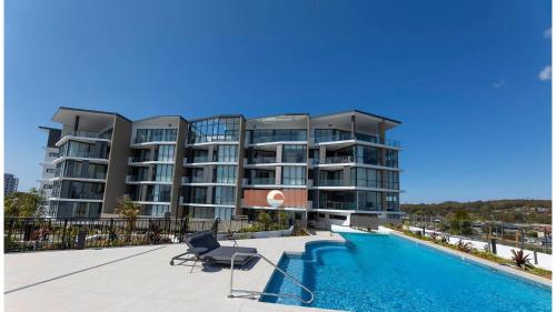 a large apartment building with a swimming pool at Solaris 410 in Forster