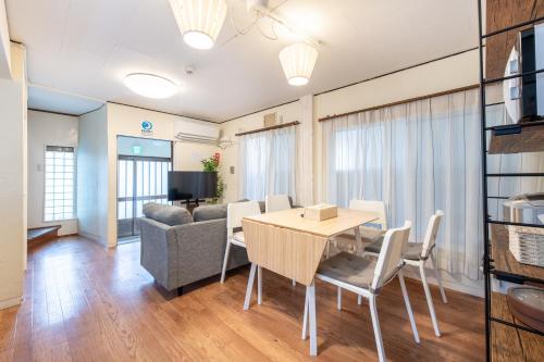 a living room with a table and a couch at 西新宿5丁目戸建 in Tokyo