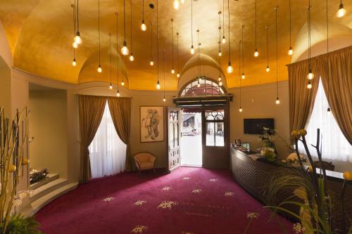 a large room with a purple carpet and lights at Grandhotel Ambassador Národní Dům in Karlovy Vary