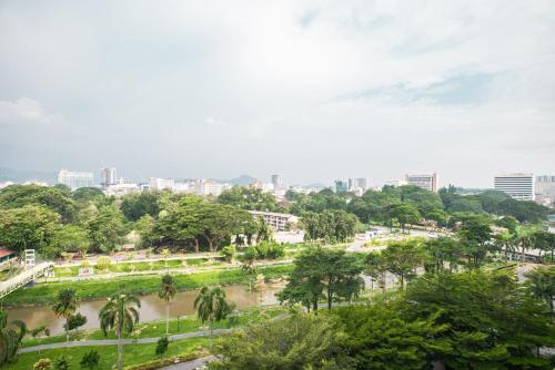 a park with trees and a city in the background at Cosy City-View Suite in Town in Ipoh
