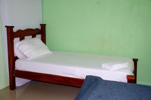 a small bedroom with two beds in a room at Natural Harmony Cabin in Puerto Jiménez