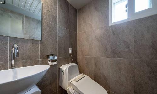 a bathroom with a white toilet and a sink at Anyang ILLOWA Hotel in Anyang