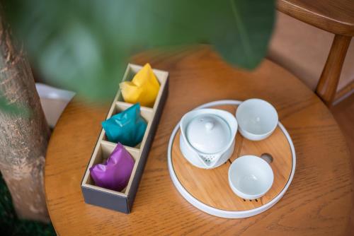 a wooden table with a toy cup and colored candles at White Swan Guest House in Zhaoqing