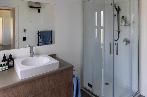 a bathroom with a sink and a shower at Tui nest in Whangamata