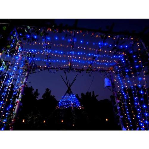 a group of blue lights in front of a christmas tree at Pernjai Homestay 2beds in Pua