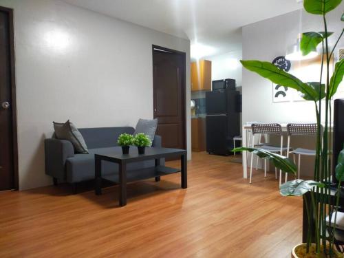 a living room with a couch and a table at Stylish 2BR w/ Free Pool Access and Parking LG03 in Manila