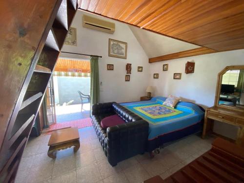 a living room with a couch and a bed at chalet chenal in Hauru