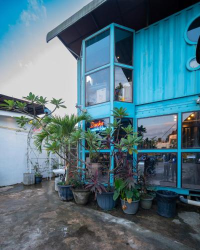 a blue building with plants in front of it at Danka Vacation Home in Seribu